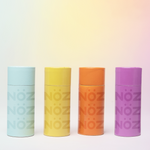 Load image into Gallery viewer, 4 sticks of Nöz&#39;s colorful mineral sunscreen sticks in the colors blue, yellow, orange and purple.
